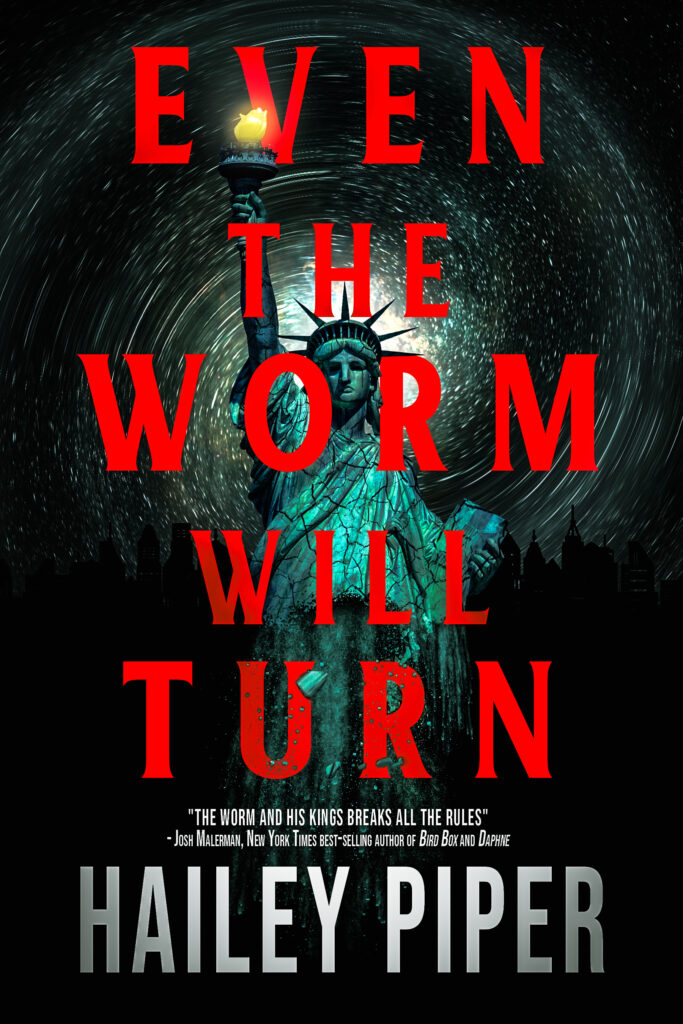 Cover for Even the Worm Will Turn featuring the statue of liberty and a galaxy swirling behind it