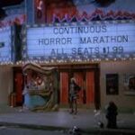 Screenshot from 976-EVIL featuring a run down theater advertising horror marathon with $1.99 seats