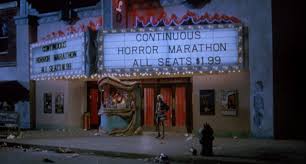 Screenshot from 976-EVIL featuring a run down theater advertising horror marathon with $1.99 seats